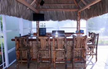 tiki hut with a pool bar and stools