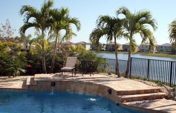 landscaped backyard with swimming pool and paver patio