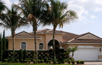 landscaped front yard plants and manicured lawn in front of a house