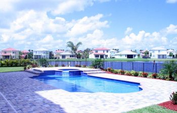 backyard swimming pool with interlocking brick paver deck