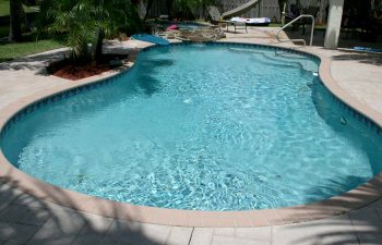 backyard swimming pool with paver deck