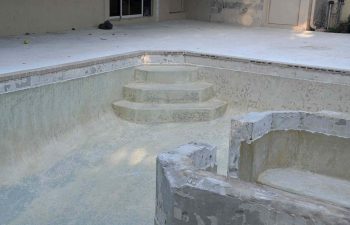 backyard swimming pool with jacuzzi and pool deck under renovation