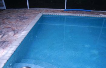 indoor swimming pool and deck before renovation