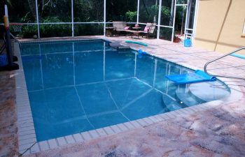 glass enclosed swimming pool and deck before renovation