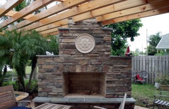 patio with an outdoor fireplace