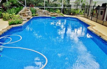 swimming pool with vinyl liners and hardscapes on the edge
