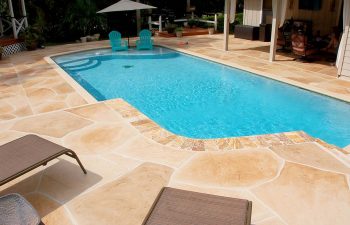 backyard swimming pool with flagstone deck