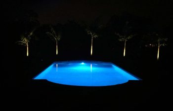 night view of a backyard swimming pool