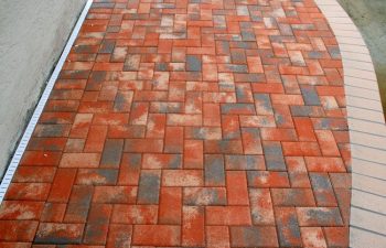 Interlocking brick paver pool deck