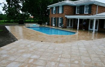 Backyard Swimming Pool With Artistic Pavers Deck