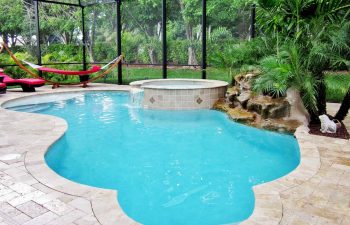 glass enclosed spa pools with hardscape waterfall