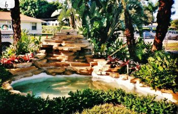 hardscape waterfall in a landscaped backyard