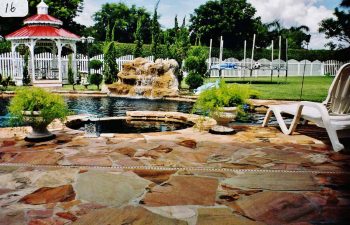 backyard spa zone and a pool with a hardscape waterfall
