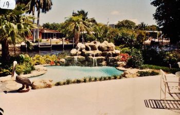 backyard swimming pool with a hardscape waterfall