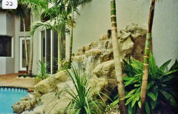 swimming pool with a hardscape waterfall