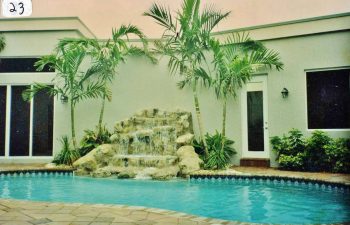 swimming pool with a hardscape waterfall