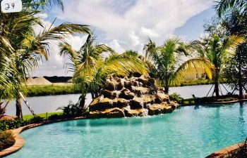 backyard swimming pool with a hardscape waterfall