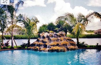 backyard swimming pool with a hardscape waterfall