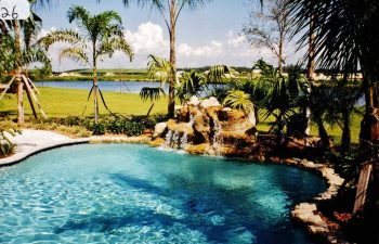 backyard swimming pool with a hardscape waterfall