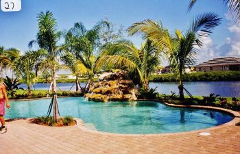 backyard swimming pool with a hardscape waterfall