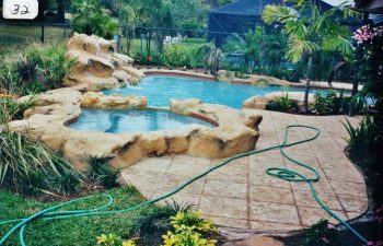 backyard spa pools with a hardscape waterfall