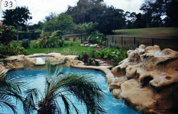 backyard spa pools with a hardscape waterfall