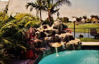 backyard swimming pool with a hardscape waterfall