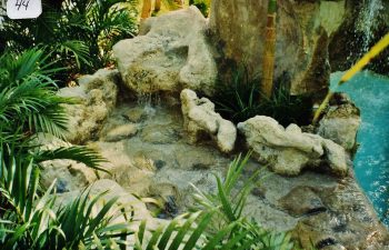 backyard swimming pool with a hardscape waterfall