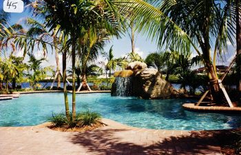 backyard swimming pool with a hardscape waterfall