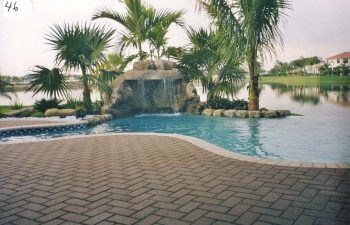 backyard swimming pool with a hardscape waterfall