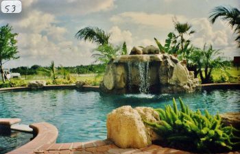backyard swimming pool with a hardscape waterfall