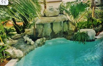 backyard swimming pool with a hardscape waterfall