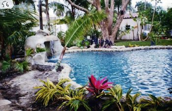 backyard swimming pool with a hardscape waterfall