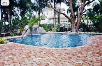 backyard swimming pool with a hardscape waterfall