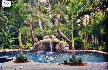 backyard swimming pool with a hardscape waterfall