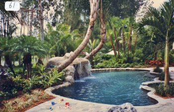 backyard swimming pool with a hardscape waterfall