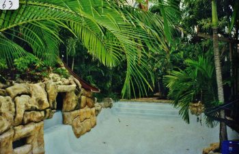 backyard swimming pool with a hardscape waterfall under construction