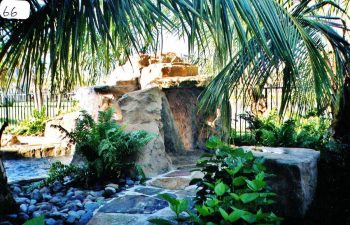 backyard swimming pool with a hardscape waterfall