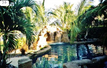 backyard swimming pool with a hardscape waterfall