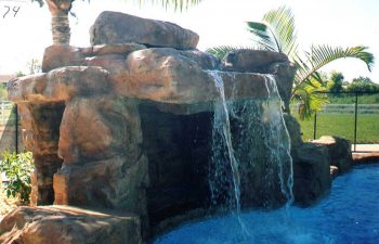 backyard swimming pool with a hardscape waterfall