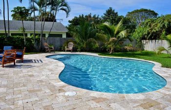 backyard swimming pool with Travertine deck