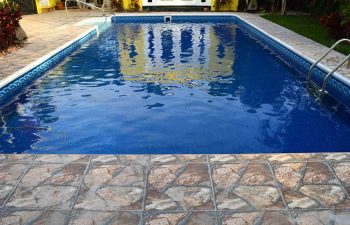 backyard in-ground swimming pool with vinyl liners and artistic pavers patio