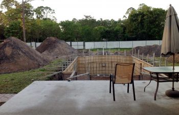 backyard swimming pool under construction