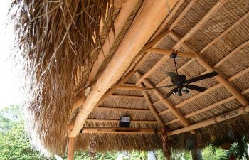 outdoor lighting installed under a tiki hut roof