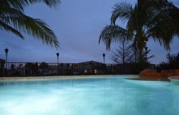 night view of a bakyard swimming pool