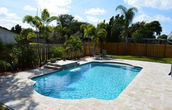 backyard swimming pool with a waterfall