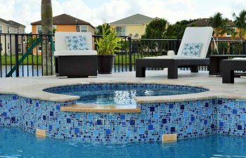 sun longers on a backyard swimming pool deck