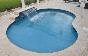 backyard pool with a waterfall