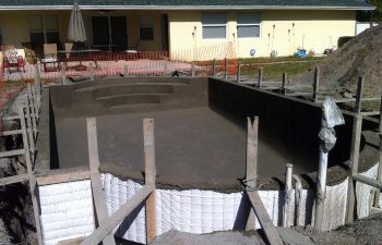 backyard swimming pool under construction