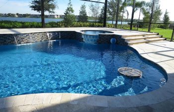 backyard indoor swimming pool with waterfall and jacuzzi